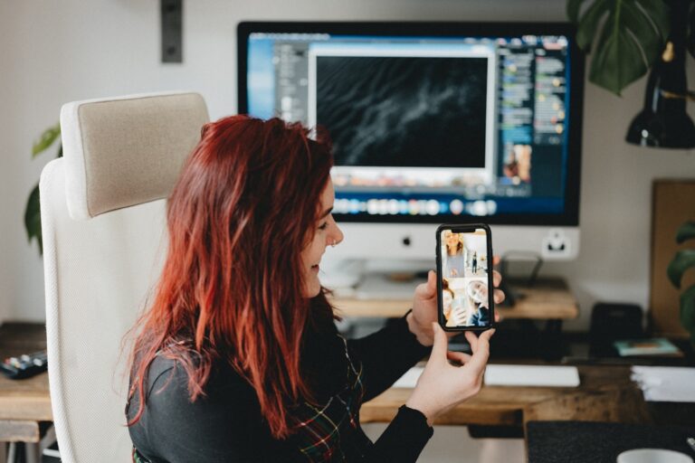 Young adult using a chat app on a phone in a cozy private setting, illustrating AI roleplay and conversational...